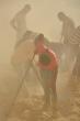Egipscy robotnicy w tumanach pyłu usuwają skalny rumosz i trap z półki skalnej..., fot. Sławomir W. Malinowski
